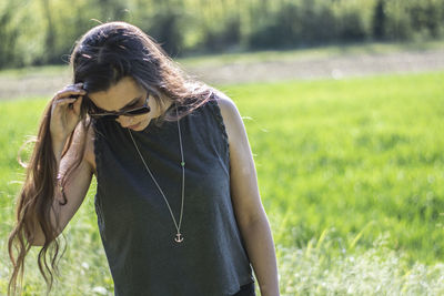 Young woman standing on field