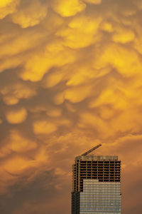 Low angle view of building against cloudy sky