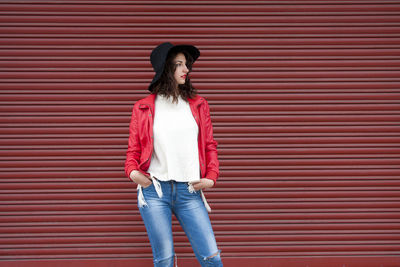 Urban fashion young woman with a red background