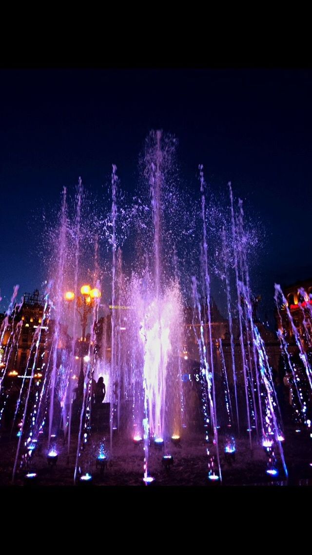 night, arts culture and entertainment, long exposure, illuminated, low angle view, no people, outdoors, motion, sky, city