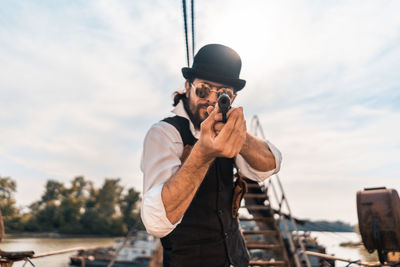 Man photographing against sky