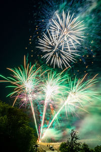 Low angle view of firework display at night