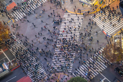 High angle view of people walking on road in city