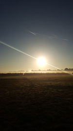 Scenic view of field against clear sky during sunset