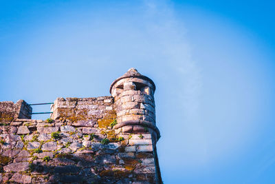 Low angle view of old building against blue sky