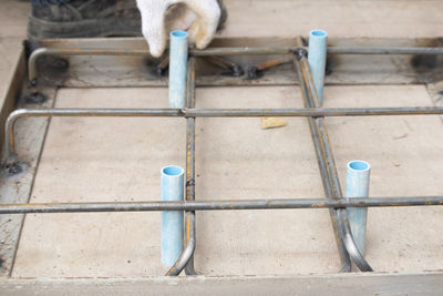 High angle view of bird on metal railing