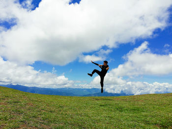 Man standing on field against sky