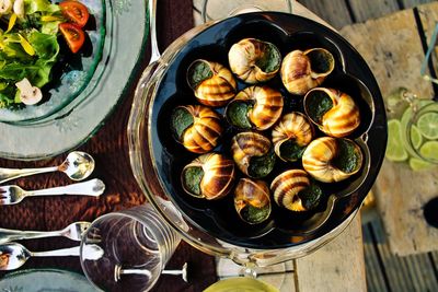 High angle view of snails served on table for dinner