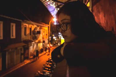 Close-up of young woman at night