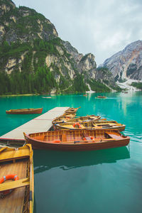 Boat moored on lake against mountains