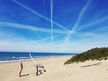 Scenic view of beach against blue sky