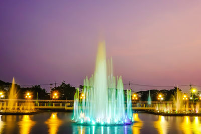 Illuminated fountain building against sky at night