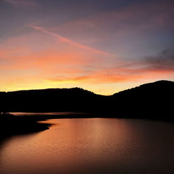 Scenic view of lake against romantic sky at sunset
