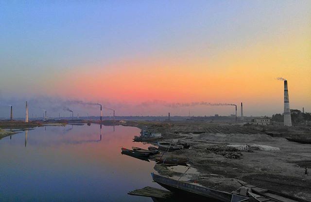 sunset, water, orange color, copy space, tranquility, scenics, beauty in nature, tranquil scene, built structure, clear sky, nature, sky, architecture, transportation, sea, rock - object, idyllic, river, waterfront, outdoors