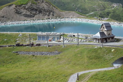 High angle view of lake and buildings against mountain