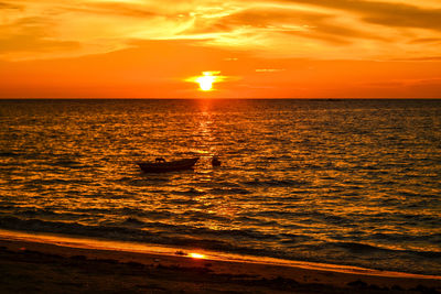 Scenic view of sea against orange sky