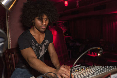 Young man djing at a night club