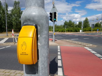 Close-up of yellow road sign on street