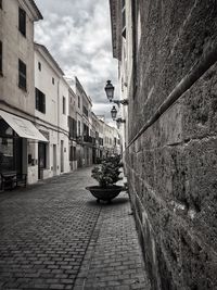 Sidewalk in city against sky