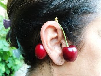 Close-up of woman with red berries