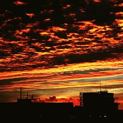 Silhouette of building against dramatic sky