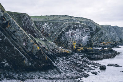 Scenic view of rock formation against sky during winter