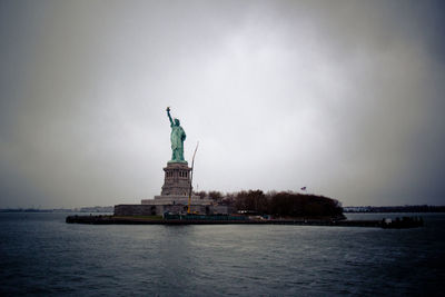 Statue of liberty against cloudy sky