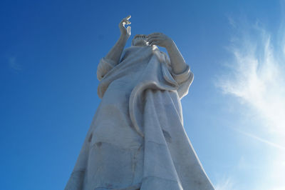 Low angle view of statue against blue sky