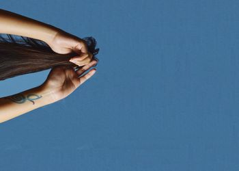 Cropped image of woman hand over white background