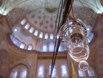 Low angle view of glass hanging from ceiling