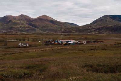 Scenic view of field and mountains against sky