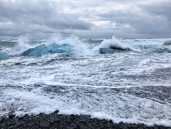 Close-up of waves in sea against sky
