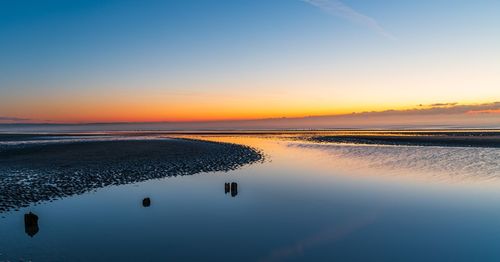 Scenic view of sea against sky during sunrise