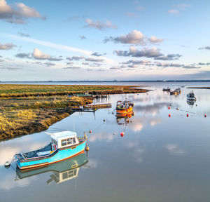 Boats moored in sea against sky