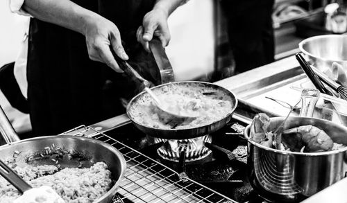 Midsection of man preparing food in kitchen