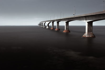 Bridge over sea against sky