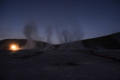 Scenic view of waterfall against sky at night