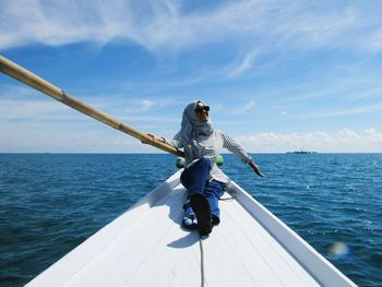 Man standing in sea against sky