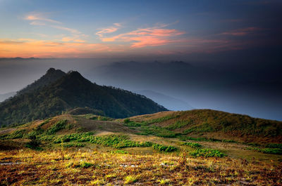 Scenic view of mountains against cloudy sky