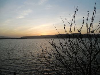 Scenic view of lake against sky during sunset