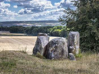 Hay bales on field against sky