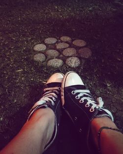 Low section of person standing on tiled floor