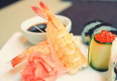 Fresh shrimps and sushi served with savory sauce