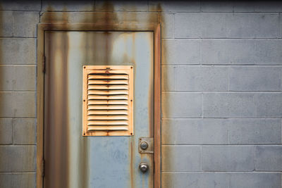 Close-up of closed door with air duct