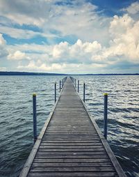 Pier over sea against sky