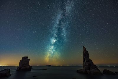 Scenic view of sea against sky at night