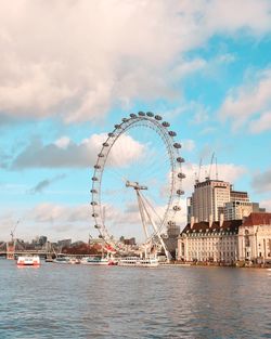 Millennium wheel in city against sky