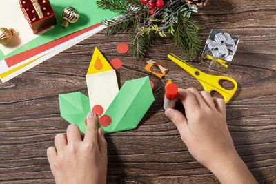 High angle view of woman hand with toy on table