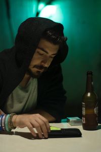 Young man having drink on table