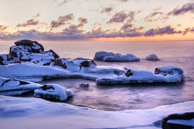 Scenic view of sea against cloudy sky
